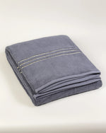 Grey Chateau Turkish cotton bath sheet, folded on a soft studio backdrop 