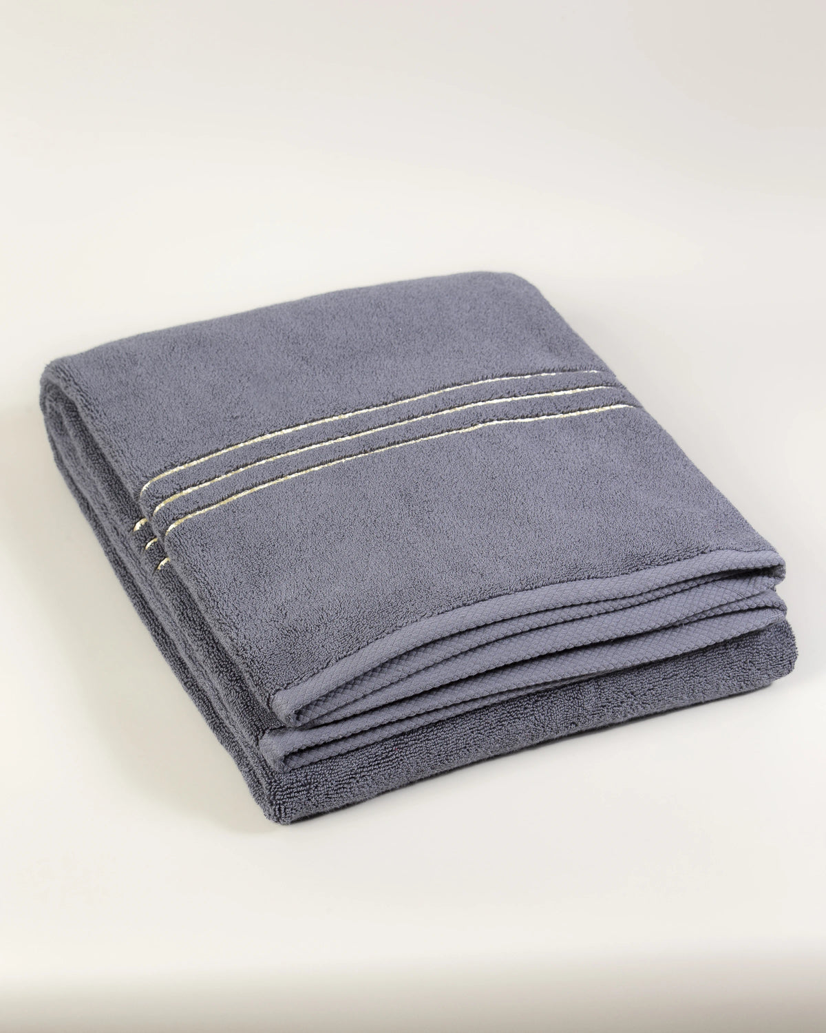 Grey Chateau Turkish cotton bath sheet, folded on a soft studio backdrop 