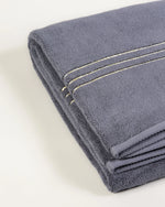 Grey Chateau Turkish cotton bath sheet, close-up of the gold dobby border and soft terry pile 