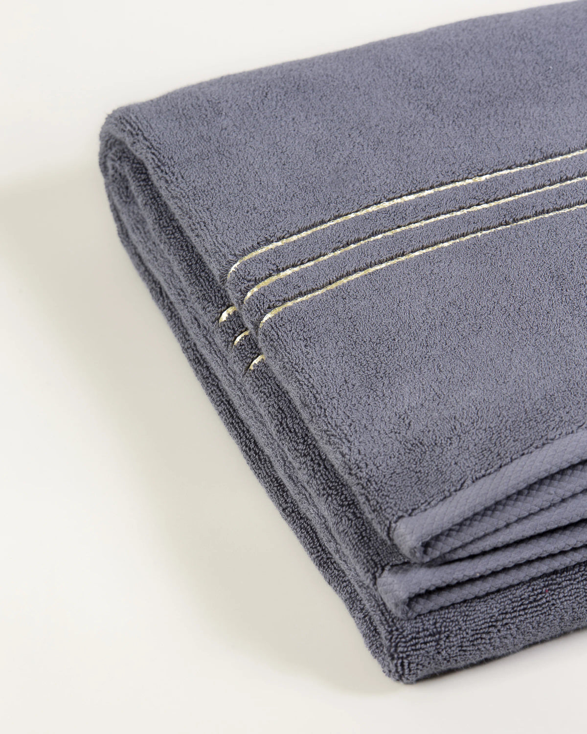 Grey Chateau Turkish cotton bath sheet, close-up of the gold dobby border and soft terry pile 