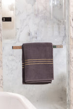 Grey Chateau Turkish cotton bath sheet, on a chrome bar in a glass shower 