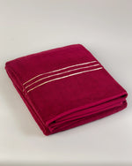 Maroon Chateau Turkish cotton bath sheet, folded on a soft studio backdrop 