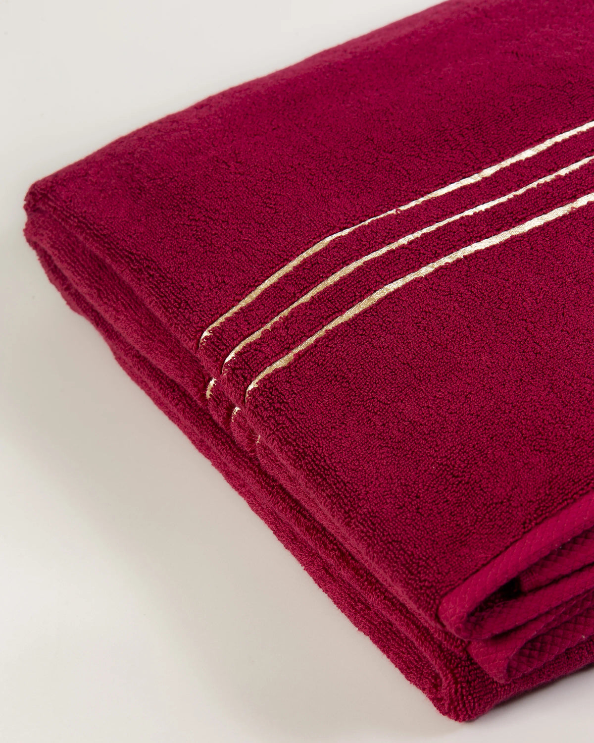 Maroon Chateau Turkish cotton bath sheet, close-up of the gold dobby border and soft terry pile 