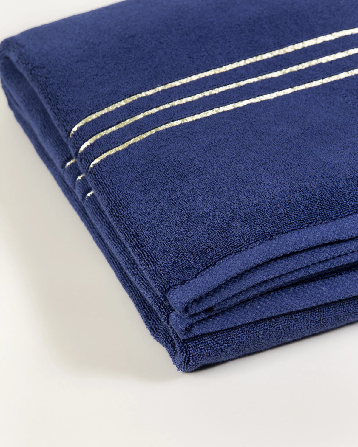 Navy Blue Chateau Turkish cotton bath sheet, close-up of the gold dobby border and soft terry pile 
