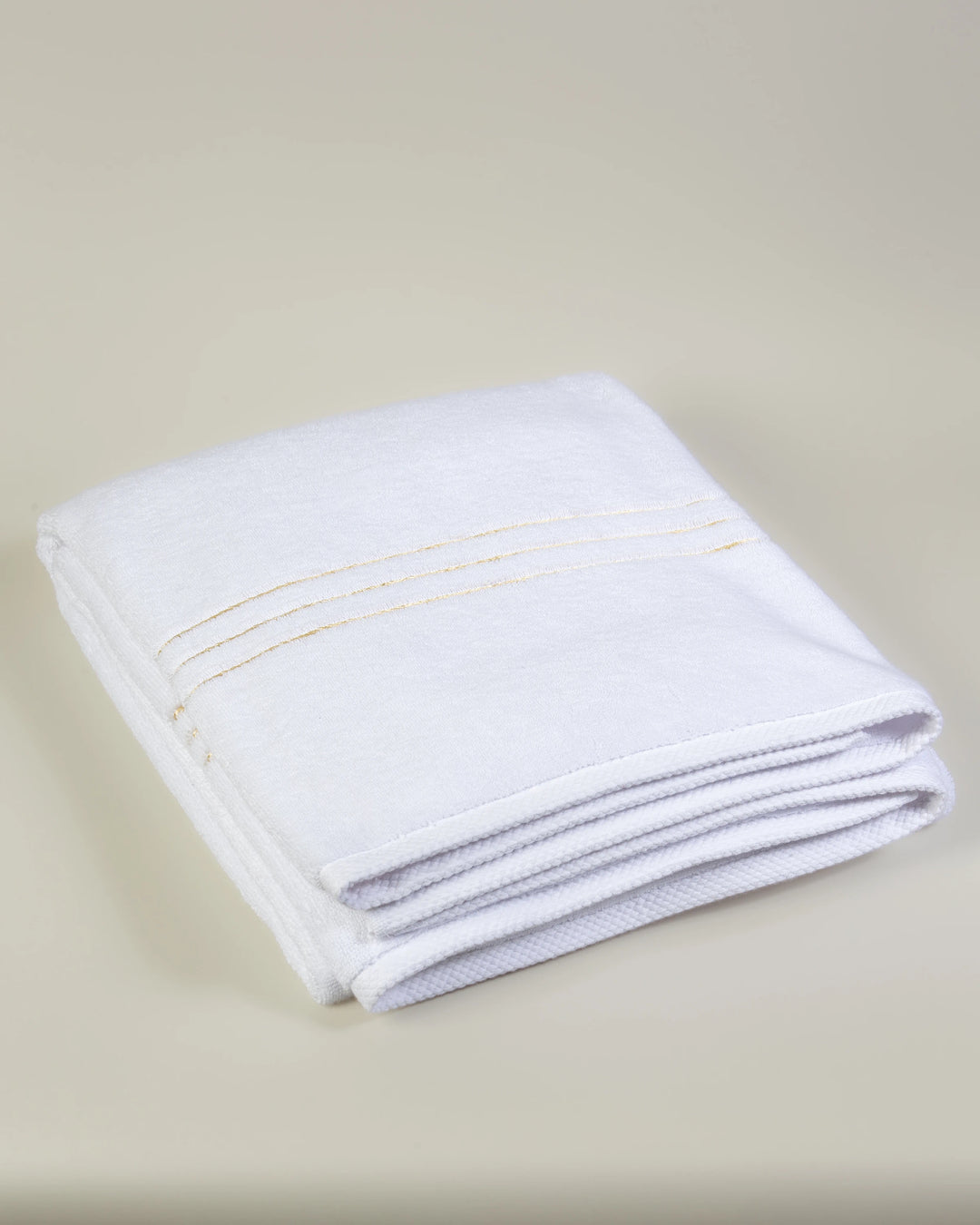 White Chateau Turkish cotton bath sheet, folded on a soft studio backdrop 