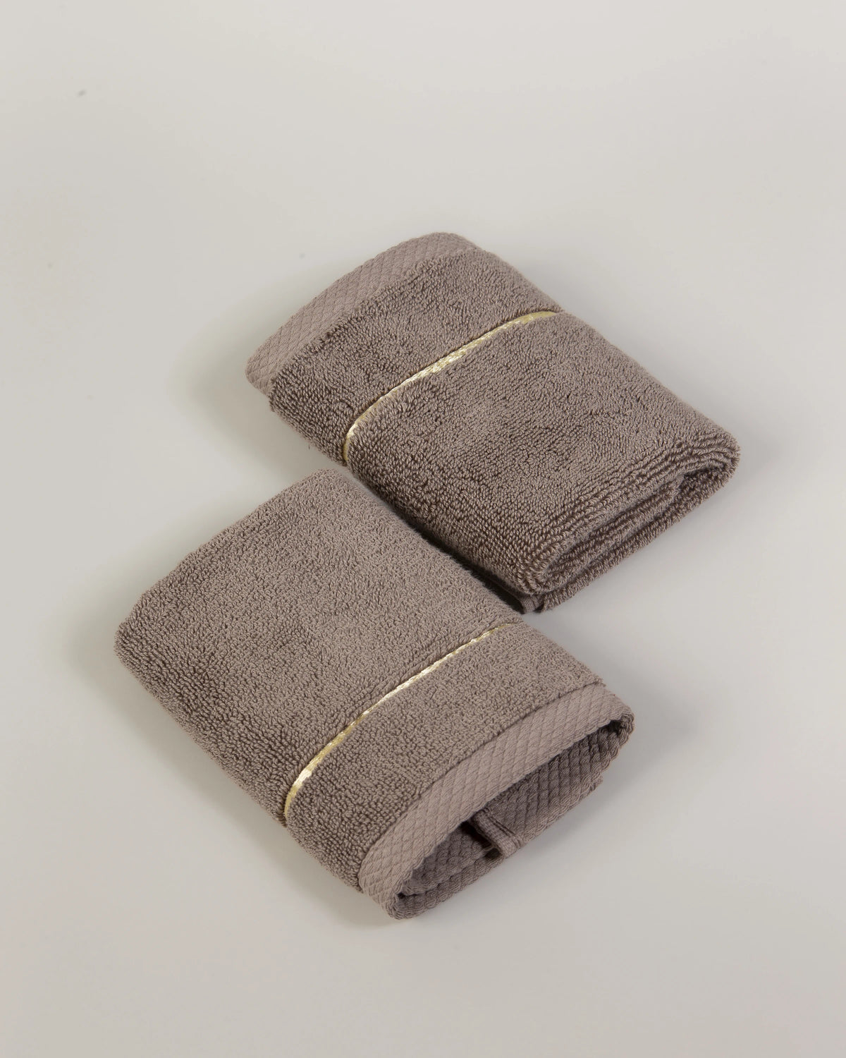 Brown Chateau Turkish cotton face towel, pair folded on a soft studio backdrop 