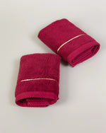 Maroon Chateau Turkish cotton face towel, pair folded on a soft studio backdrop 