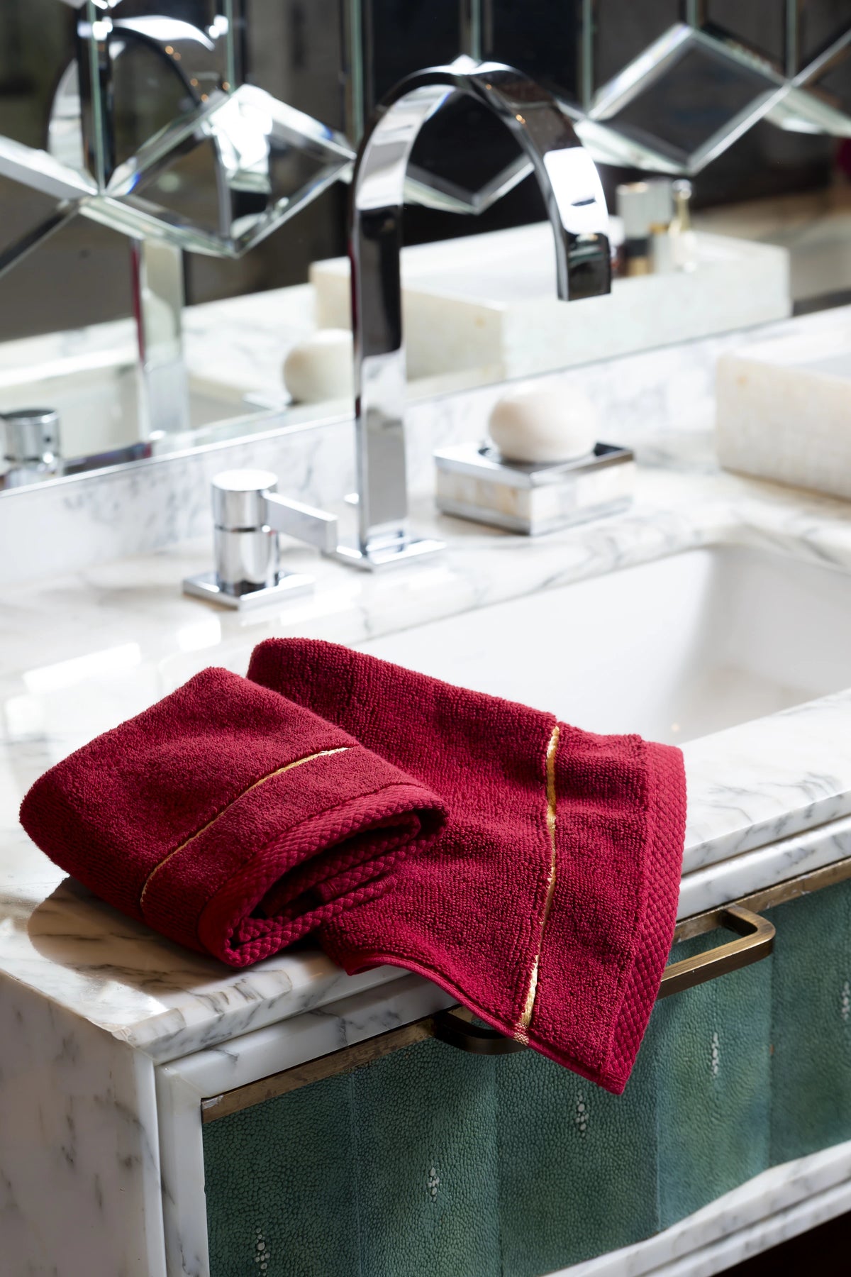 Maroon Chateau Turkish cotton face towel, on a marble vanity 