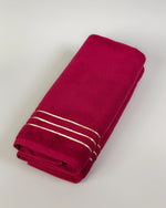 Maroon Chateau Turkish cotton hand towel, folded on a soft studio backdrop 