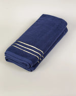 Navy Blue Chateau Turkish cotton hand towel, folded on a soft studio backdrop 