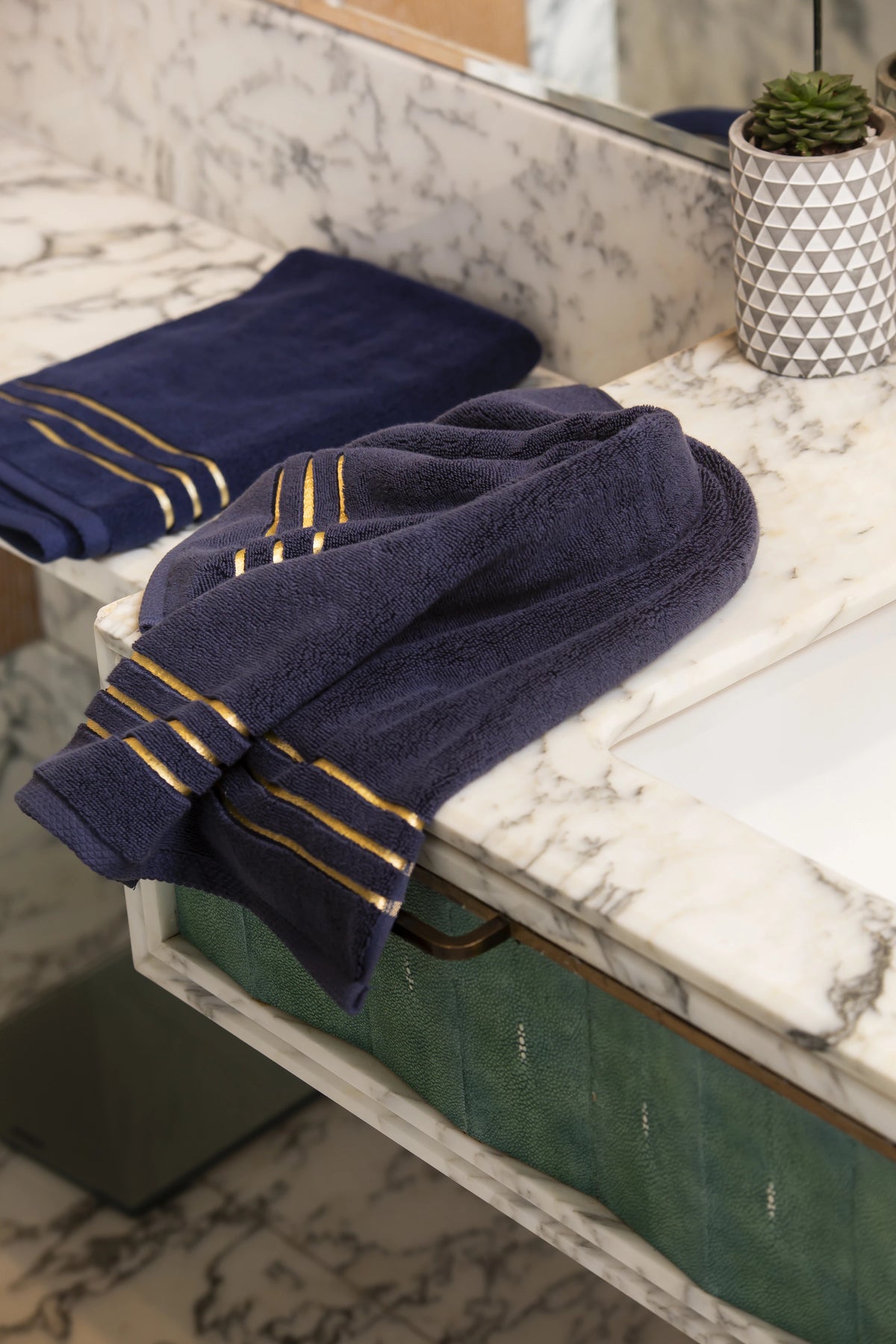 Navy Blue Chateau Turkish cotton hand towel, on a marble vanity 