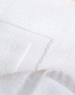Macro detail of Retreat bath mat 1000 GSM cotton frame border weave in white