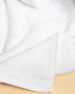 Close-up of Retreat white cotton terry with its flat twill hem