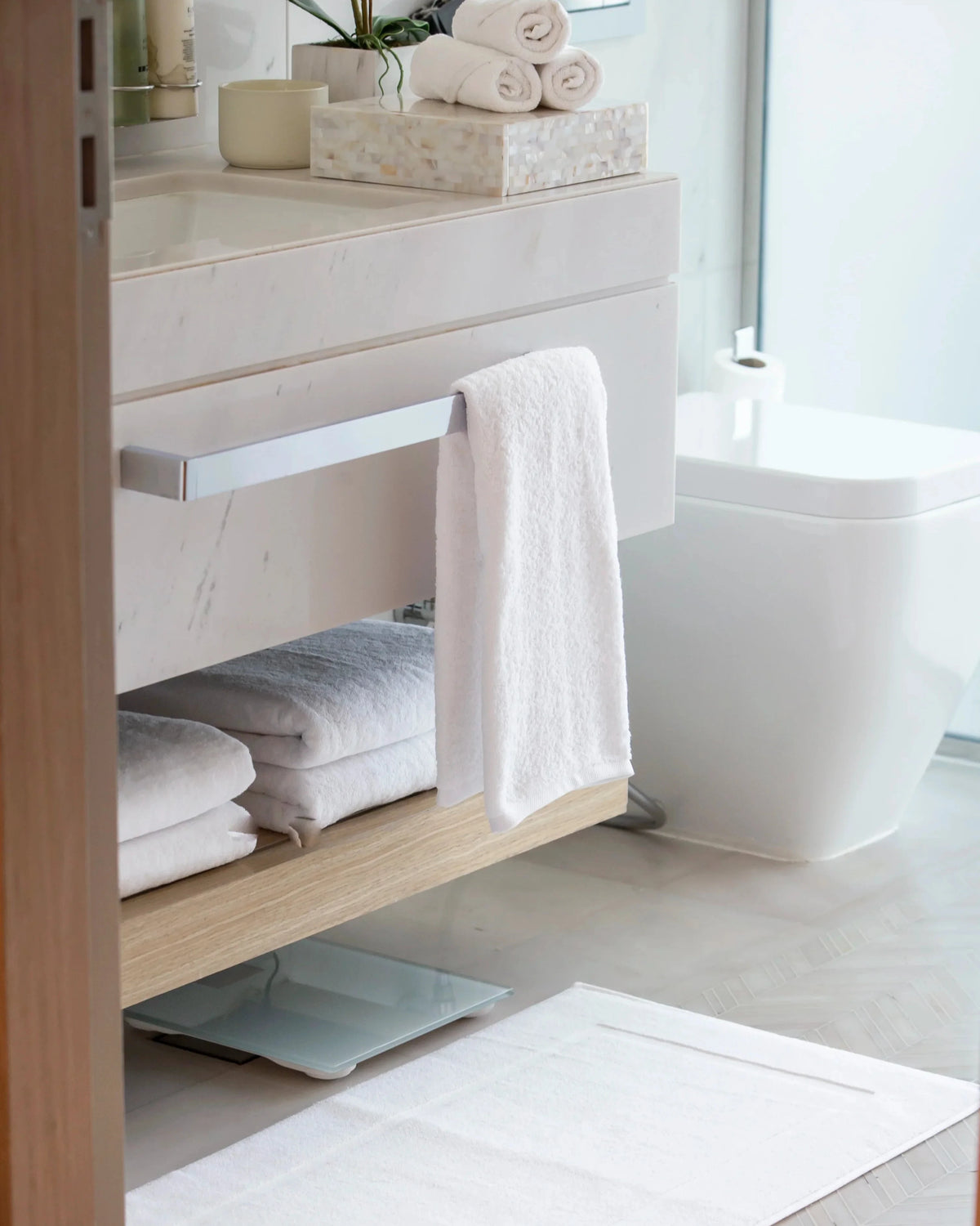 Retreat Complete Set white towels and bath mat in a bright bathroom