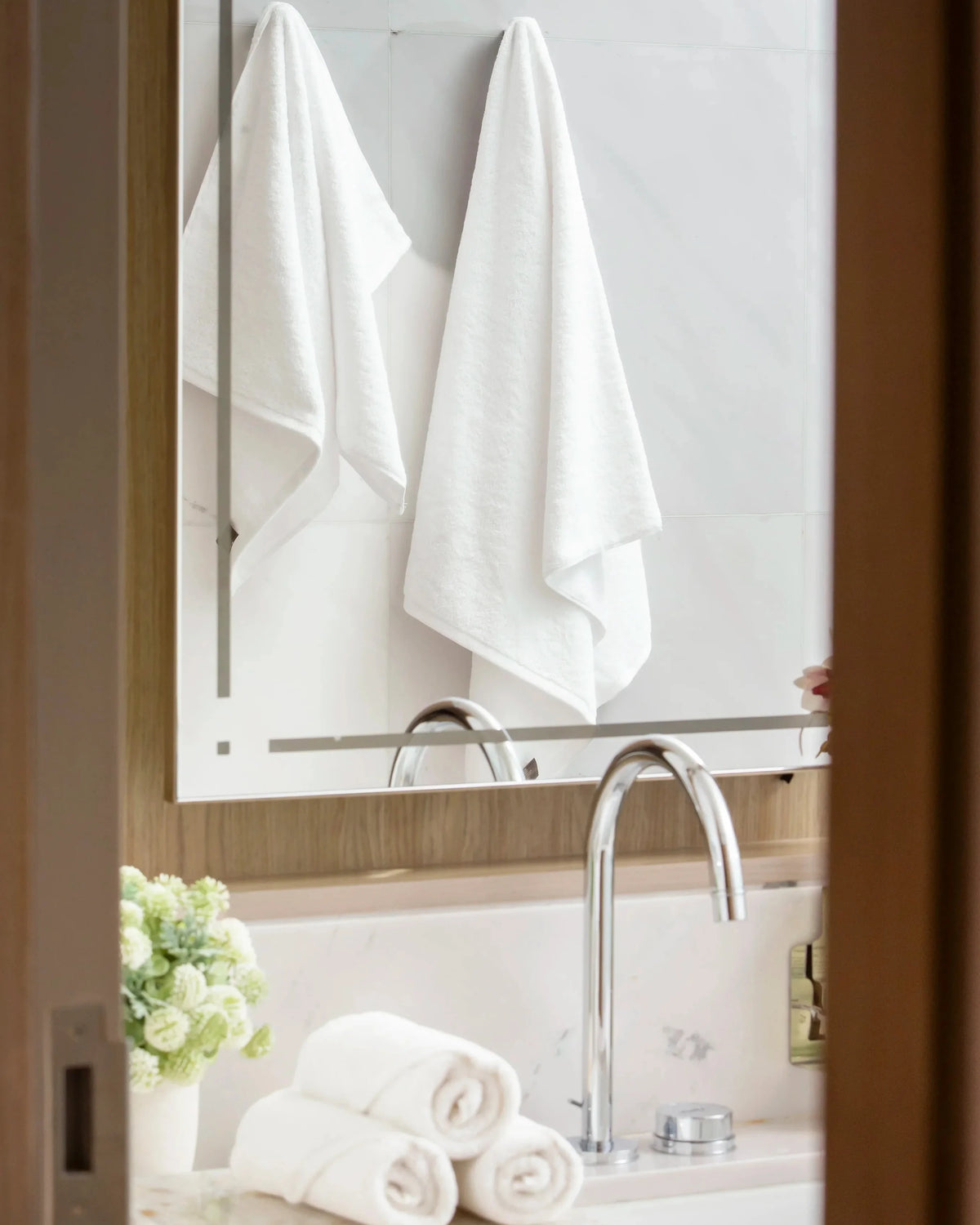 Retreat Complete Set white cotton towels hanging in a marble bathroom