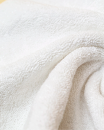 Macro detail of Retreat face towel soft 650 GSM cotton terry weave in white