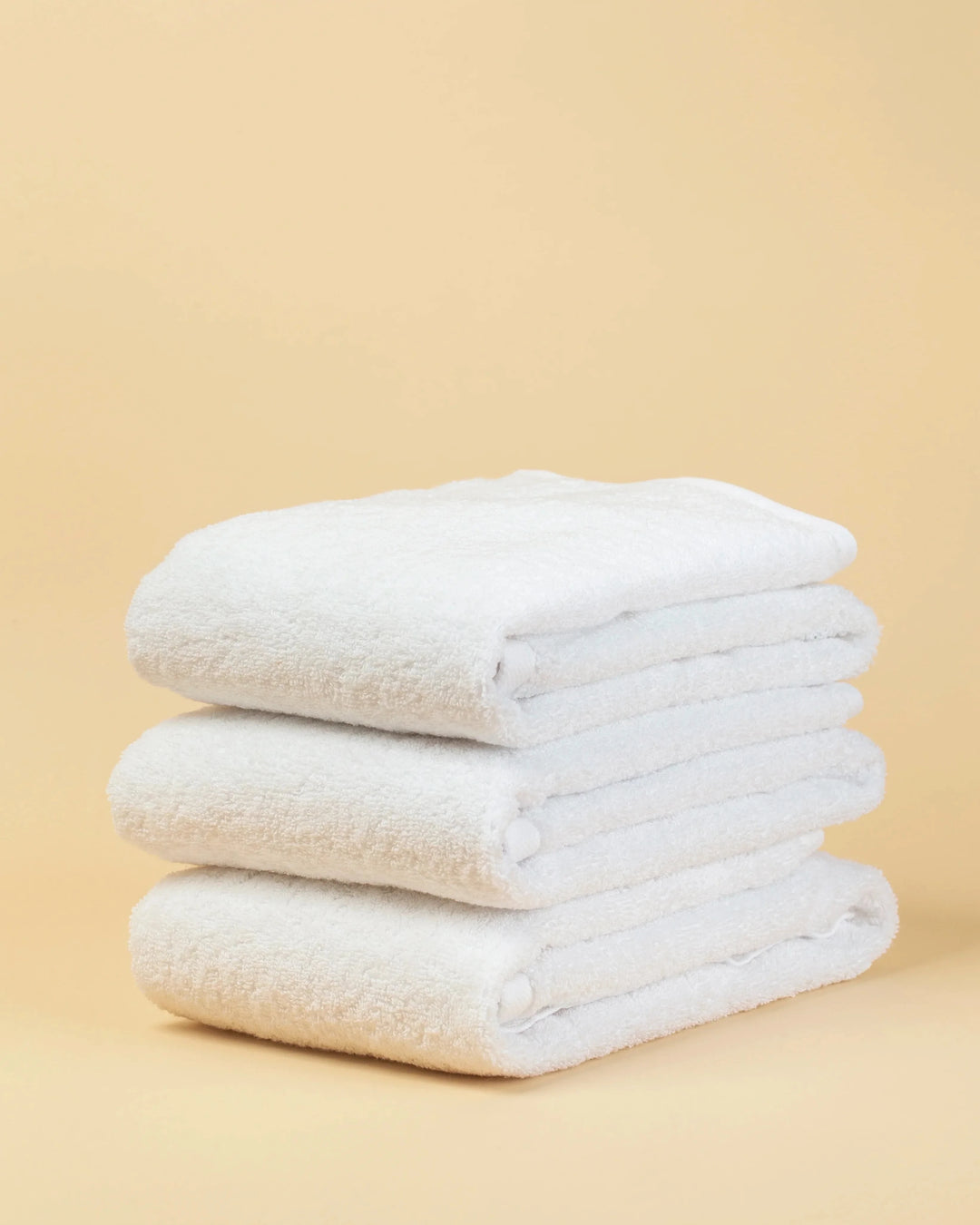 Maison 1952 Retreat hand towel in white, 650 GSM 100% cotton, stack of three folded towels