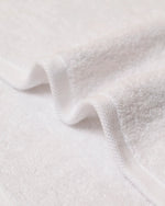 Macro detail of Retreat hand towel 650 GSM cotton terry pile and twill border