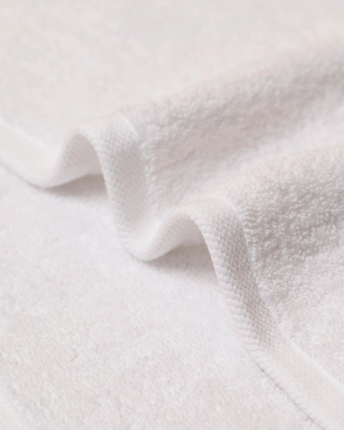 Macro detail of Retreat hand towel 650 GSM cotton terry pile and twill border